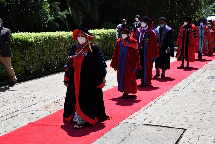 The procession led by the Chancellor Dr Vijoo Rattansi leaves the great court