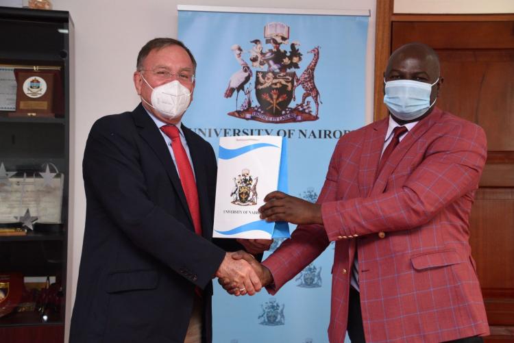 VC representative Mr Brian Ouma the Director of University Advancement gives REA Vipingo MD Mr Neil Cuthbert a small token of appreciation during his courtesy call to the VC