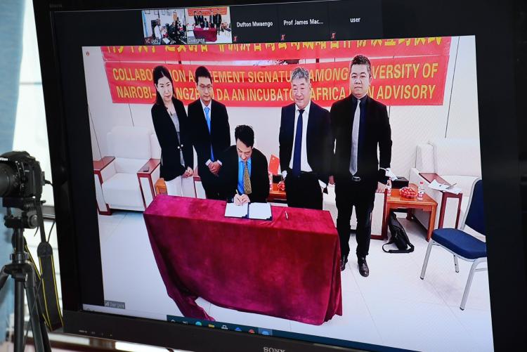 Da An Gene executives sign the collaborative agreement between UoN, ALA and Da An Gene during the virtual ceremony