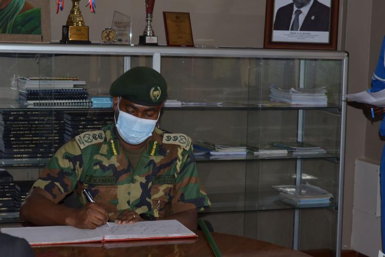 Chief Conservator of Forests (KFS) Mr. Julius Kamau signs the visitors book