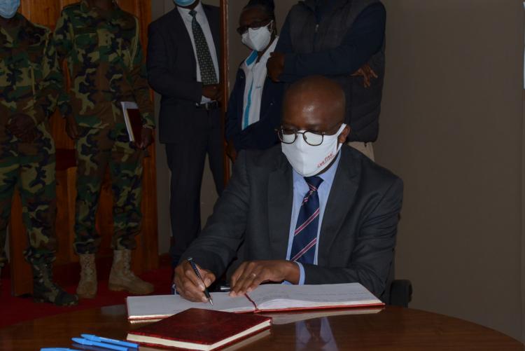 Equity Group Chief Commercial Officer Mr Polycarp Igathe signs the visitors book
