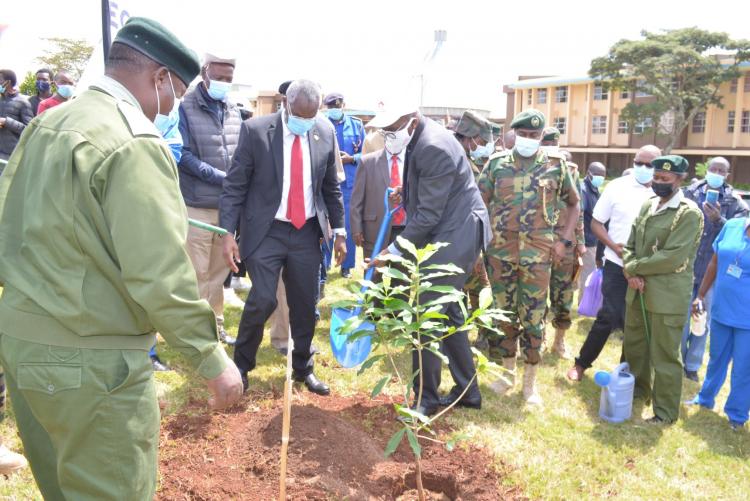 Equity Group Holdings Chief Commercial Officer, Mr Polycarp Igathe plants a tree as the VC Prof Stephen Kiama and KFS Chief Conservator of Forests Mr Julius Kamau look on